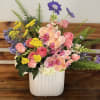 Soft peach and pink orchids paired with gentle pink roses and cloudlike