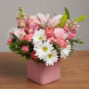 Pink and white mixed bouquet in a pink square vase