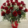 Bouquet of red roses with baby's breath in a glass vase