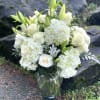 White roses and hydrangeas in a glass vase