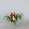 Red roses and white lilies in a clear glass vase