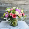 Mixed pink and white roses in a glass vase