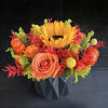 Orange rose and sunflower arrangement in a black vase