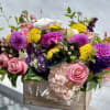 Colorful mixed flower arrangement in a wooden box