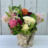 Mixed bouquet of roses and dahlias in a birch-style container