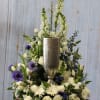 White and purple floral arrangement in a silver vase