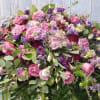 Large bouquet of pink and purple roses with mixed greenery