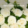 Close-up of white roses and ranunculus over mossy green accents with text reading White and Green Designer's Choice