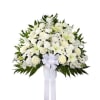 Large standing spray of white lilies, roses, and other flowers with a white bow and long ribbons