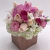 Pink and white floral arrangement in a square vase