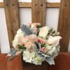 Pastel roses and hydrangeas arranged in a wooden box