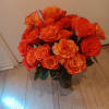 Bouquet of orange roses in a glass vase