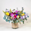 Bright and cheerful, this garden-inspired arrangement bursts with vibrant yellows and striking