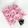 Box of pink roses in a clear gift box with a ribbon