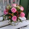 Pink roses arranged in a clear glass vase