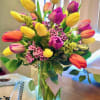 Colorful tulip bouquet in a clear glass vase