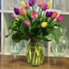 Colorful tulip bouquet in a clear glass vase
