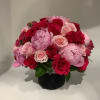 Bouquet of red and pink roses in a black vase