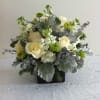 White roses and green-white flowers in a black square vase