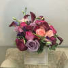 Bouquet of roses and calla lilies in pink, purple, and burgundy tones