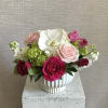 Bouquet of pink and white roses in a white ceramic vase