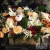 Autumn floral arrangement with white and orange blooms in a rectangular container