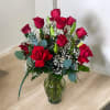 Red roses and white baby's breath in a glass vase
