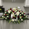 Large red and white funeral spray with roses and lilies