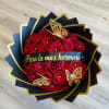 Red rose bouquet with gold butterfly decorations and a black ribbon
