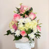 A delicate basket with soft pink roses, alstroemeria, and hydrangeas. Graceful and