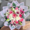 A timeless arrangement of soft pink and creamy white roses paired with