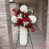 Standing cross arrangement with red roses, white lilies, and white chrysanthemums