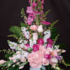 Tall pink and white floral arrangement in a white vase