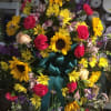 Large wreath with sunflowers, carnations, and a teal ribbon bow