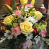 Mixed bouquet of yellow roses, daisies, carnations, and tulips