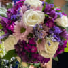 Bouquet of white roses, pink daisies, and purple flowers