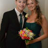 Teen couple dressed for a formal event, holding a colorful bouquet