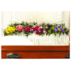 Colorful floral casket spray with roses and daisies
