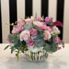 Pink and white floral arrangement in a clear glass vase