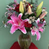 Pink lilies and red roses in a glass vase