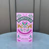 Pink box of Hampstead organic wild rosehip and hibiscus herbal tea on a round table.