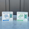 Two Honey Hill Farm bar soap boxes, Clean Rain and Rosemary Mint, on a light stone surface
