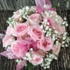 Pink roses with babies breath with a pink bow for just the