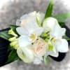 Roses with orchids a hint of greenery. The deluxe version includes a