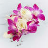 Pink orchids corsage. The deluxe version includes a matching boutonniere. The roses