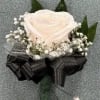 White rose, babies breath, tulle, and bow. The roses and bow can
