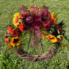 Sunflower and rose wreath with a burgundy bow on a grapevine base