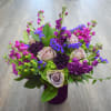 Purple and pink mixed bouquet in a dark vase