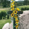Sunflower garland draped over a large cross outdoors