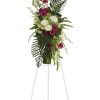 Tall floral standing spray with pink and white blooms on an easel